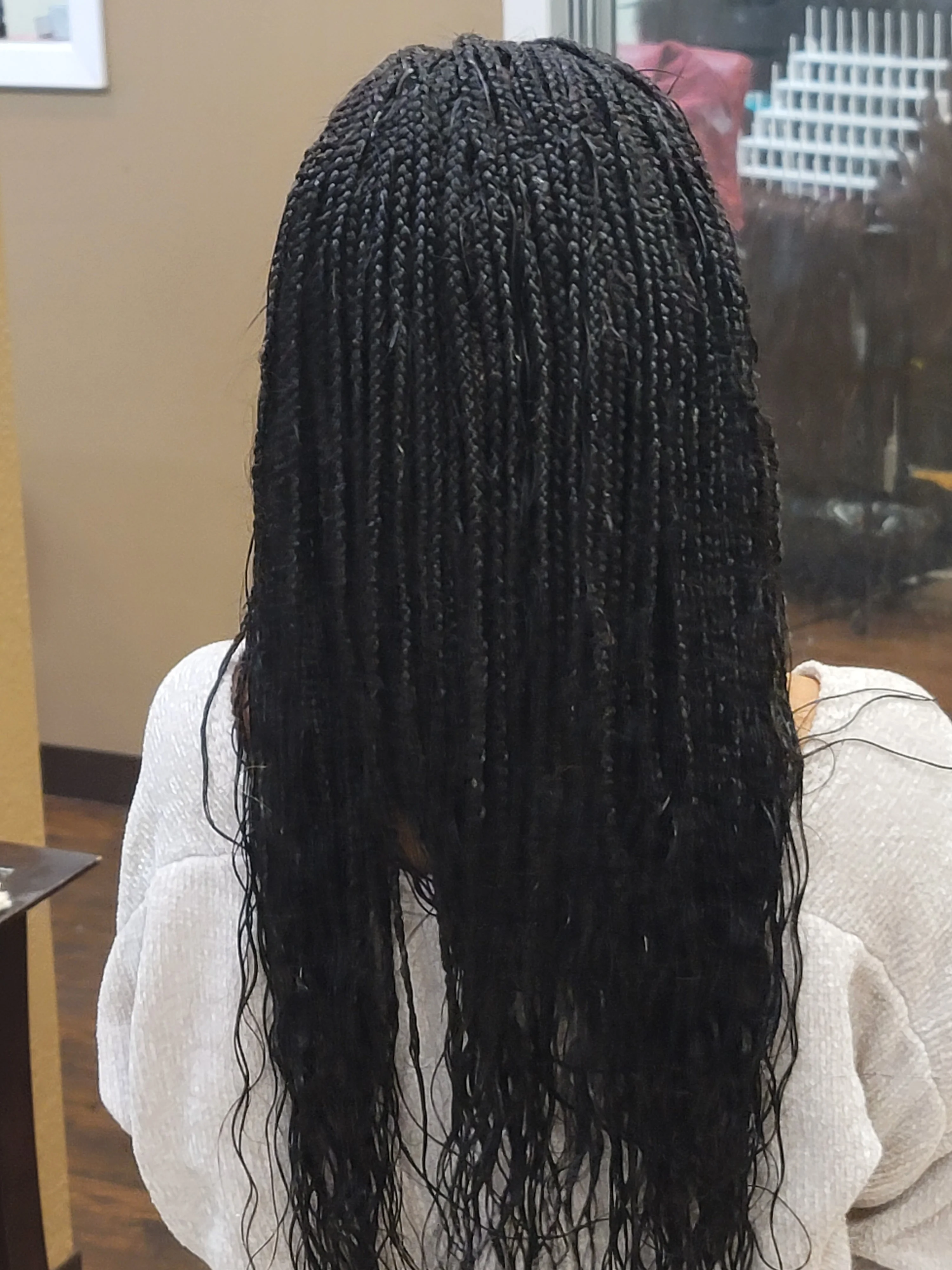 A person cutting another person 's hair with scissors.